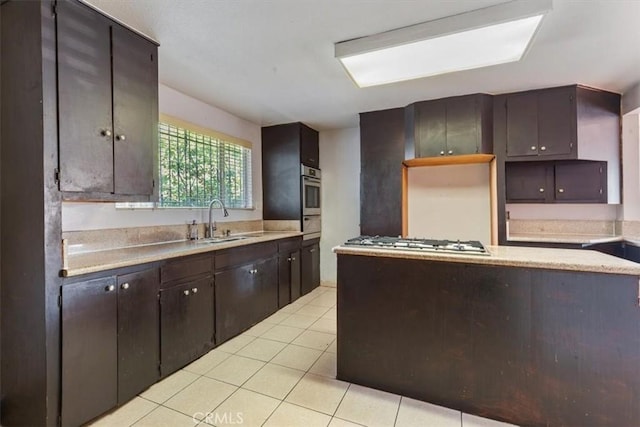 347 E 97th St, Los Angeles, CA 90003 - kitchen with stainless steel appliances, light tile patterned floors, light countertops, and dark brown cabinets