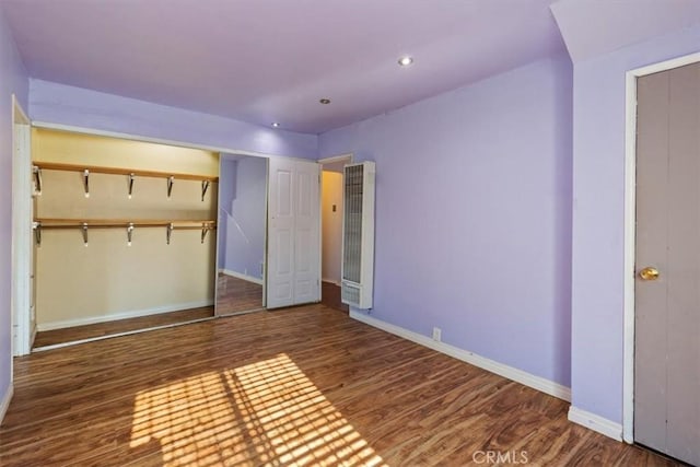 347 E 97th St, Los Angeles, CA 90003 - unfurnished bedroom with a heating unit, wood finished floors, and recessed lighting