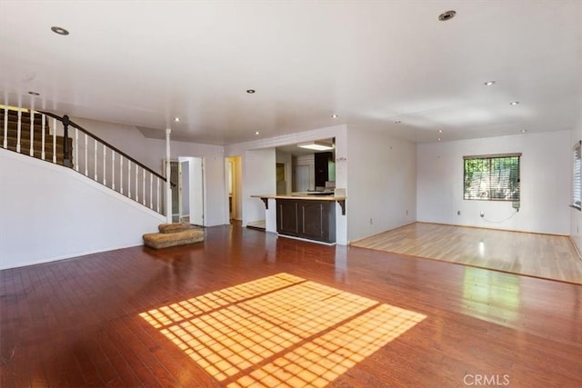 347 E 97th St, Los Angeles, CA 90003 - unfurnished living room featuring hardwood / wood-style flooring, stairway, and recessed lighting