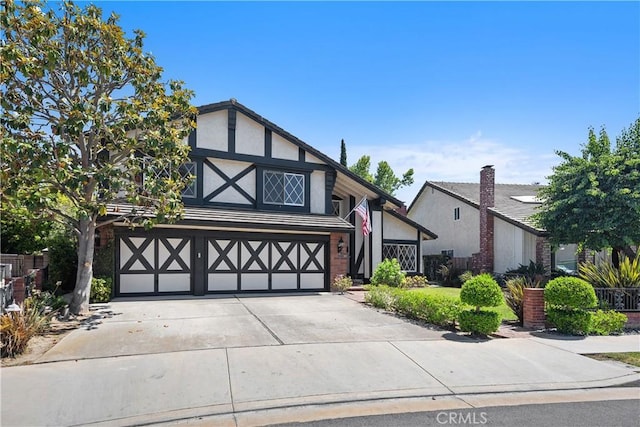 24002 Plover Ln, Laguna Niguel, CA 92677 - tudor home featuring an attached garage, stucco siding, and concrete driveway