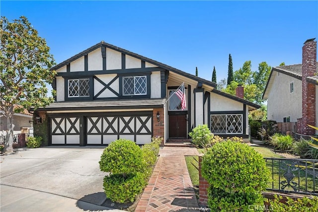24002 Plover Ln, Laguna Niguel, CA 92677 - english style home featuring stucco siding, a garage, concrete driveway, and a chimney