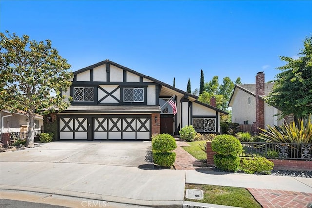 24002 Plover Ln, Laguna Niguel, CA 92677 - english style home with a garage, concrete driveway, and stucco siding