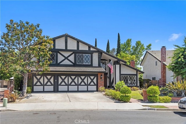 24002 Plover Ln, Laguna Niguel, CA 92677 - tudor house with stucco siding, a garage, and driveway