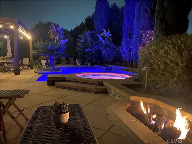 24002 Plover Ln, Laguna Niguel, CA 92677 - pool at twilight with a fire pit, an in-ground hot tub, an outdoor pool, and a patio