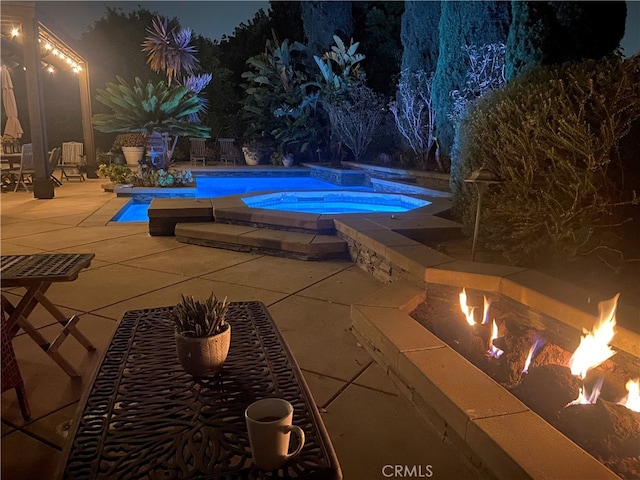 24002 Plover Ln, Laguna Niguel, CA 92677 - pool at night featuring a patio area and an outdoor pool