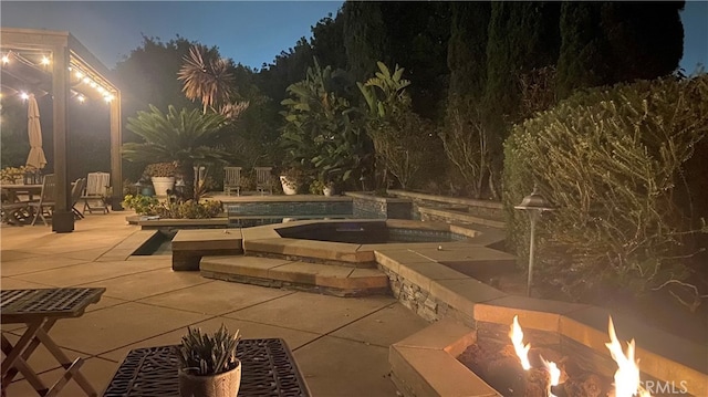 24002 Plover Ln, Laguna Niguel, CA 92677 - patio at twilight featuring a patio, an outdoor pool, an in-ground hot tub, and a fire pit