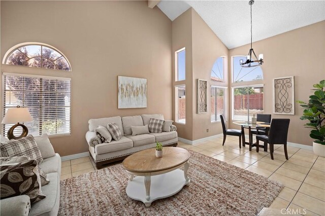 37826 Sweetbrush St, Palmdale, CA 93552 - living area featuring a chandelier, high vaulted ceiling, light tile patterned floors, and plenty of natural light