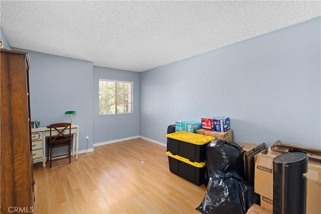 37826 Sweetbrush St, Palmdale, CA 93552 - miscellaneous room featuring light wood-type flooring and a textured ceiling