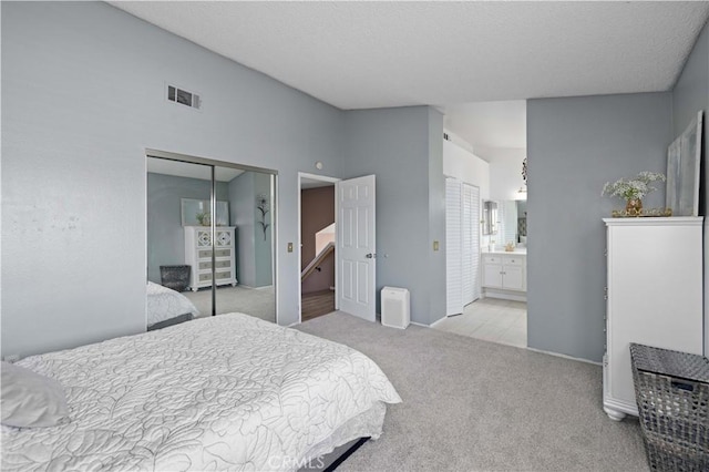 37826 Sweetbrush St, Palmdale, CA 93552 - bedroom with light carpet, a closet, lofted ceiling, and ensuite bathroom
