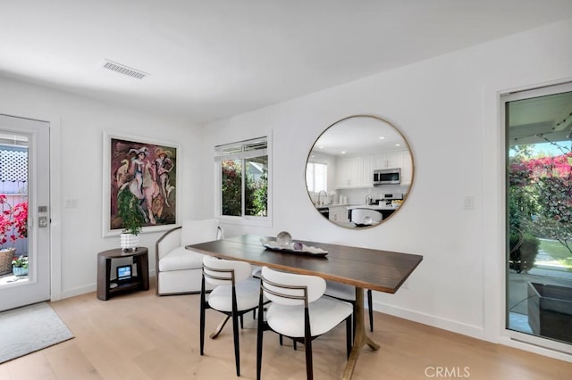 23451 Friar St, Woodland Hills, CA 91367 - dining area featuring light wood-type flooring and plenty of natural light