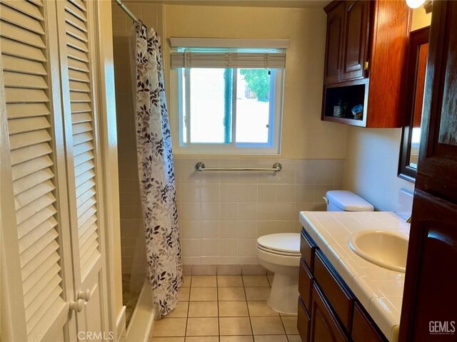 2720 Baylor St, Bakersfield, CA 93305 - full bath with tile walls, vanity, tile patterned flooring, a shower with shower curtain, and wainscoting