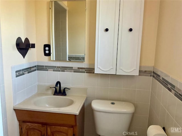 2720 Baylor St, Bakersfield, CA 93305 - half bath with vanity, wainscoting, and tile walls