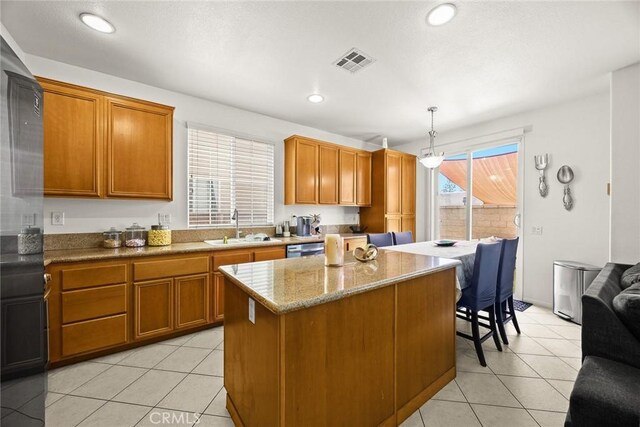1711 Lordsburg Ct, La Verne, CA 91750 - kitchen with a kitchen island, light tile patterned floors, brown cabinetry, a breakfast bar, and recessed lighting