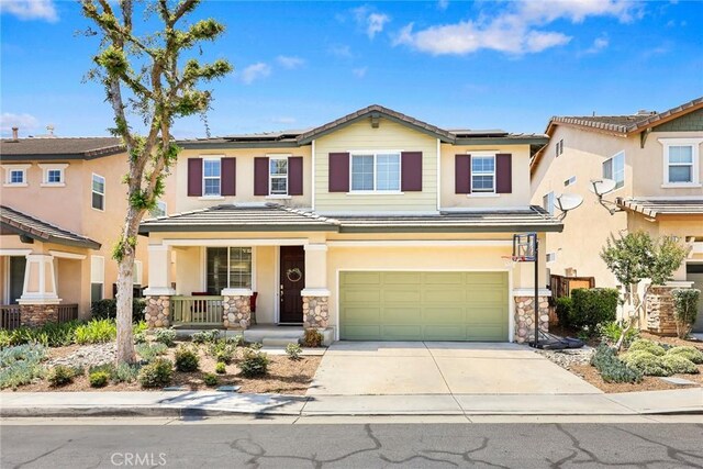1711 Lordsburg Ct, La Verne, CA 91750 - view of front of home featuring a porch, an attached garage, solar panels, driveway, and stone siding