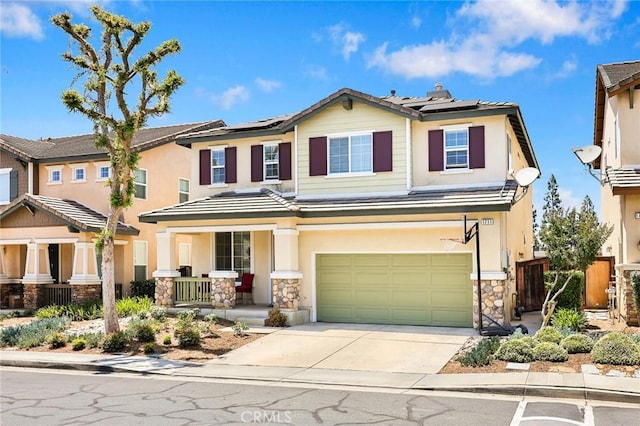 1711 Lordsburg Ct, La Verne, CA 91750 - view of front of property featuring covered porch, a garage, solar panels, driveway, and stucco siding