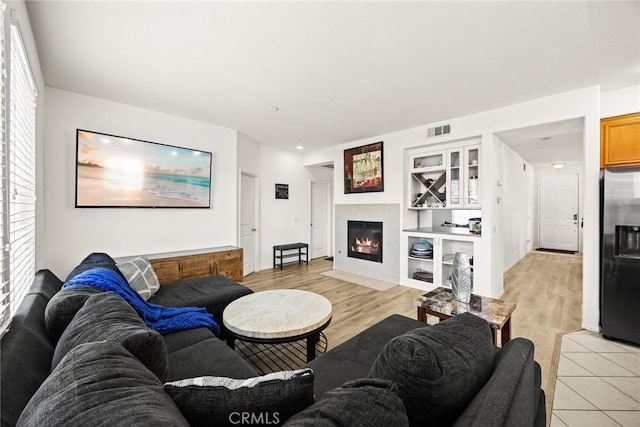 1711 Lordsburg Ct, La Verne, CA 91750 - living area with a fireplace with flush hearth, healthy amount of natural light, light wood finished floors, and built in shelves