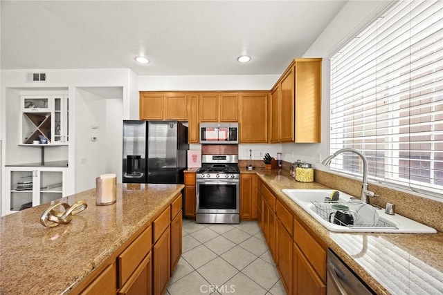 1711 Lordsburg Ct, La Verne, CA 91750 - kitchen featuring stainless steel appliances, light tile patterned floors, light stone countertops, brown cabinetry, and recessed lighting