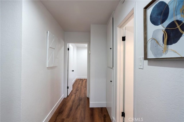 3644 Ardilla Ave, Baldwin Park, CA 91706 - hallway with baseboards and dark wood-style floors