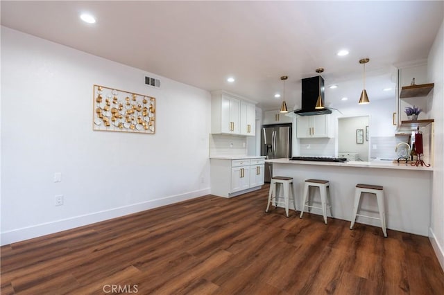 3644 Ardilla Ave, Baldwin Park, CA 91706 - kitchen featuring island range hood, a peninsula, stainless steel fridge, white cabinets, and backsplash