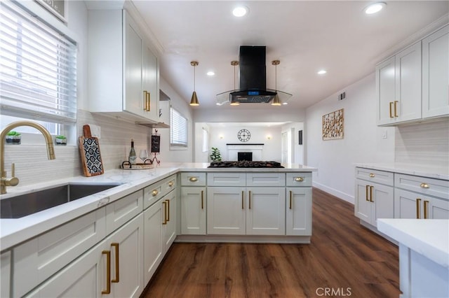 3644 Ardilla Ave, Baldwin Park, CA 91706 - kitchen featuring exhaust hood, a peninsula, backsplash, black gas cooktop, and recessed lighting