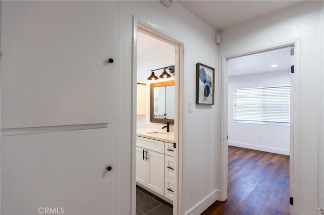 3644 Ardilla Ave, Baldwin Park, CA 91706 - hallway featuring a sink and dark wood-style floors