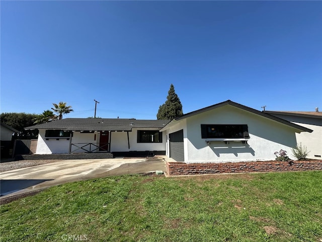 259 Freda Ave, Pomona, CA 91767 - ranch-style home with an attached garage, stucco siding, a front yard, and concrete driveway