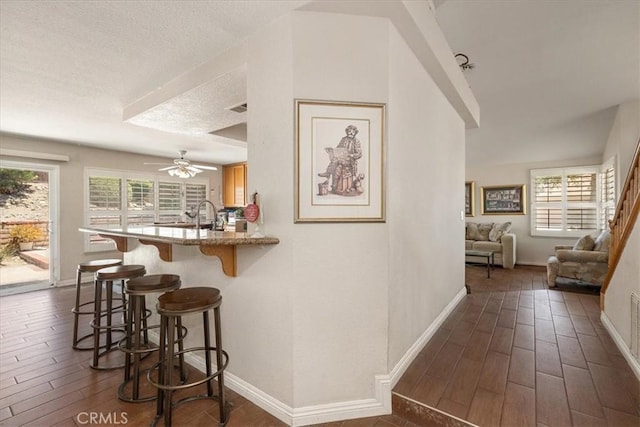 1413 Daisy St, Upland, CA 91784 - bar area with dark wood-style flooring, ceiling fan, and a textured ceiling
