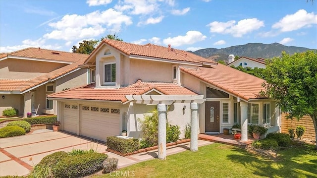 1413 Daisy St, Upland, CA 91784 - mediterranean / spanish house featuring driveway, stucco siding, a tiled roof, and a mountain view