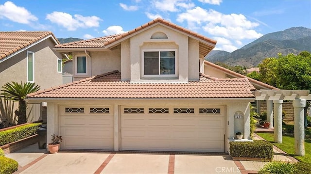 1413 Daisy St, Upland, CA 91784 - mediterranean / spanish house with a mountain view, driveway, a tile roof, and stucco siding