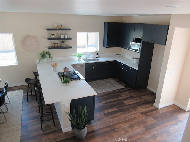 7906 Curbaril Ave, Atascadero, CA 93422 - kitchen featuring a breakfast bar, open shelves, a peninsula, dark wood-style flooring, and dark cabinets