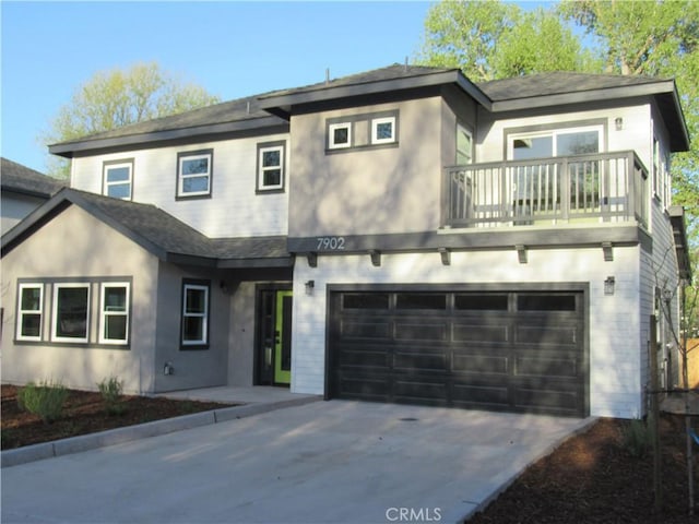 7906 Curbaril Ave, Atascadero, CA 93422 - view of front facade featuring concrete driveway, a balcony, an attached garage, and a shingled roof