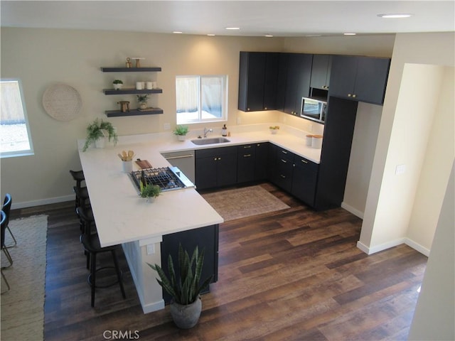 7906 Curbaril Ave, Atascadero, CA 93422 - kitchen with open shelves, a peninsula, appliances with stainless steel finishes, a breakfast bar area, and light countertops