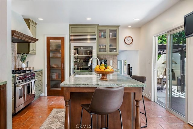 1335 Crestview Ave, Seal Beach, CA 90740 - kitchen with stainless steel appliances, premium range hood, a breakfast bar, backsplash, and light stone counters