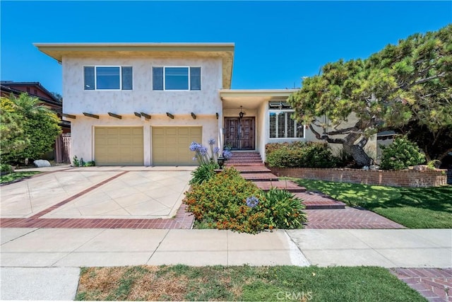 1335 Crestview Ave, Seal Beach, CA 90740 - view of front facade featuring stucco siding, concrete driveway, and an attached garage