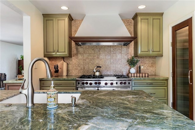 1335 Crestview Ave, Seal Beach, CA 90740 - kitchen with premium range hood, stainless steel stove, dark stone counters, tasteful backsplash, and recessed lighting