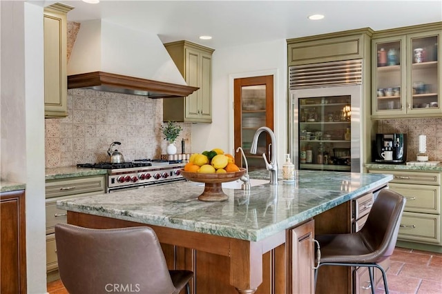 1335 Crestview Ave, Seal Beach, CA 90740 - kitchen featuring premium range hood, appliances with stainless steel finishes, a kitchen breakfast bar, cream cabinets, and recessed lighting