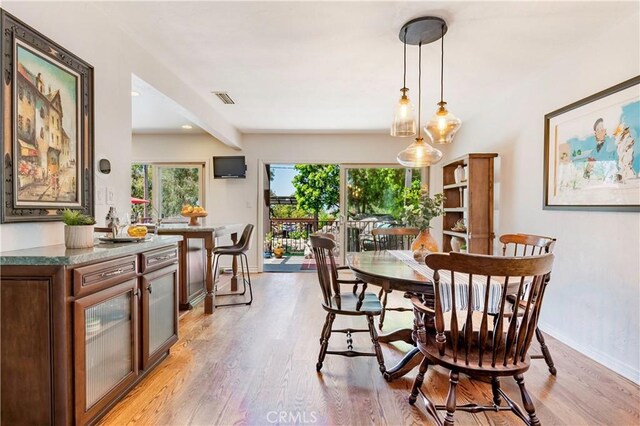 1335 Crestview Ave, Seal Beach, CA 90740 - dining room with light wood finished floors and baseboards