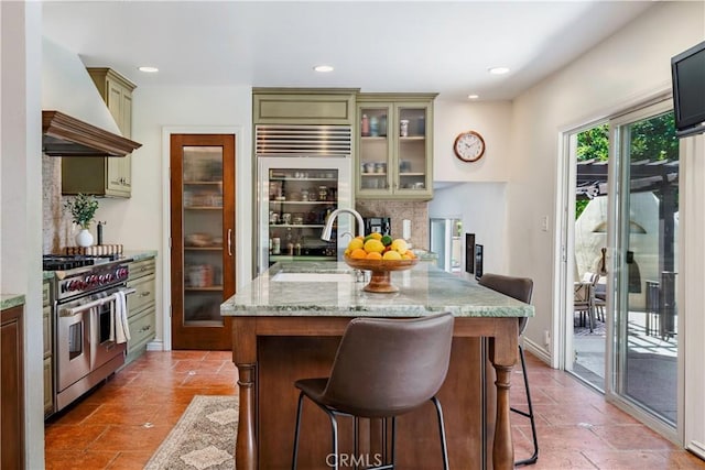 1335 Crestview Ave, Seal Beach, CA 90740 - kitchen with appliances with stainless steel finishes, custom range hood, a kitchen breakfast bar, tasteful backsplash, and light stone countertops