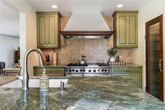 1335 Crestview Ave, Seal Beach, CA 90740 - kitchen with premium range hood, stainless steel range, dark stone counters, backsplash, and recessed lighting