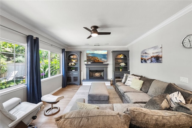 12554 Tejas Ct, Rancho Cucamonga, CA 91739 - living area featuring light wood finished floors, ornamental molding, a ceiling fan, and a warm lit fireplace