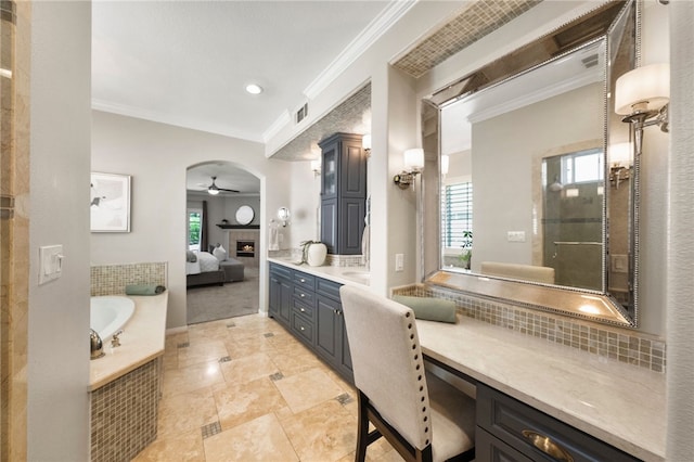 12554 Tejas Ct, Rancho Cucamonga, CA 91739 - bathroom with crown molding, a ceiling fan, a garden tub, vanity, and a tile fireplace