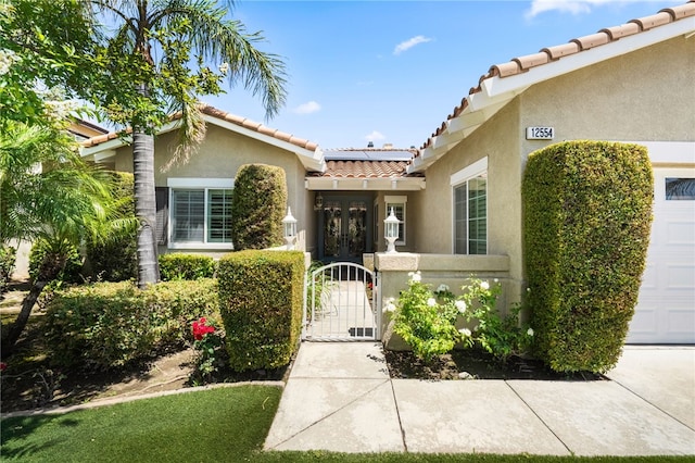 12554 Tejas Ct, Rancho Cucamonga, CA 91739 - doorway to property featuring a gate, stucco siding, a tiled roof, and french doors