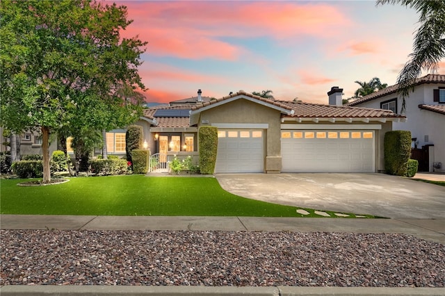 12554 Tejas Ct, Rancho Cucamonga, CA 91739 - mediterranean / spanish-style house featuring stucco siding, an attached garage, a tiled roof, a lawn, and driveway