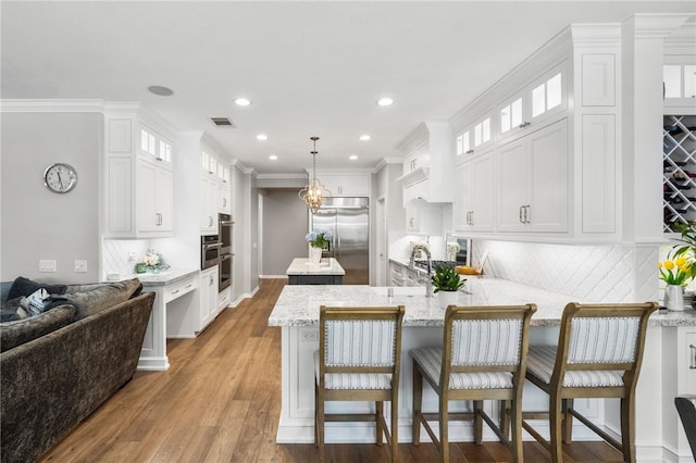 12554 Tejas Ct, Rancho Cucamonga, CA 91739 - kitchen with stainless steel built in fridge, a center island, a peninsula, tasteful backsplash, and white cabinetry