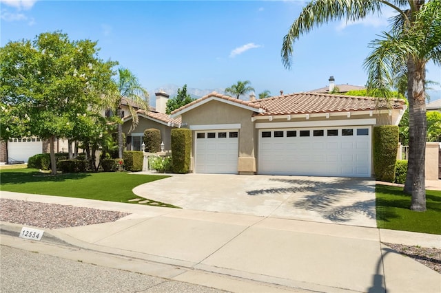 12554 Tejas Ct, Rancho Cucamonga, CA 91739 - view of front of property with stucco siding, a garage, a tile roof, a front yard, and concrete driveway