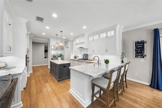 12554 Tejas Ct, Rancho Cucamonga, CA 91739 - kitchen with white cabinets, stainless steel appliances, tasteful backsplash, glass insert cabinets, and recessed lighting