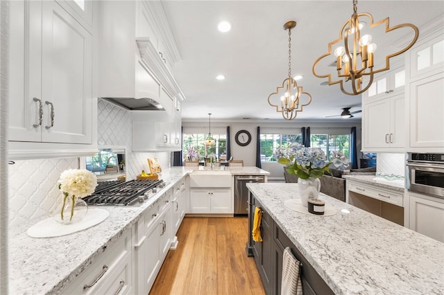 12554 Tejas Ct, Rancho Cucamonga, CA 91739 - kitchen with stainless steel appliances, a chandelier, white cabinetry, recessed lighting, and light wood-style floors