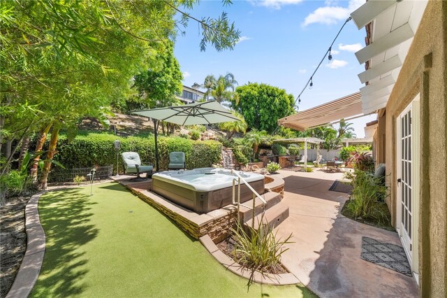 12554 Tejas Ct, Rancho Cucamonga, CA 91739 - fenced backyard featuring a hot tub, a putting green, and a patio area