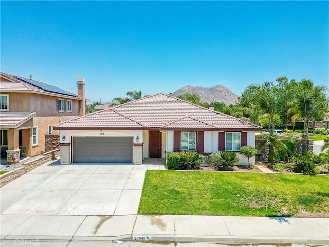 26946 Shelter Cove Ct, Menifee, CA 92585 - ranch-style home with a garage, stucco siding, driveway, a tiled roof, and a front lawn