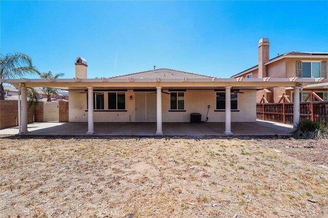 26946 Shelter Cove Ct, Menifee, CA 92585 - rear view of house featuring ceiling fan, a patio area, stucco siding, and a chimney
